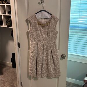 Elegant Beige Sleeveless Dress with Gold Accents